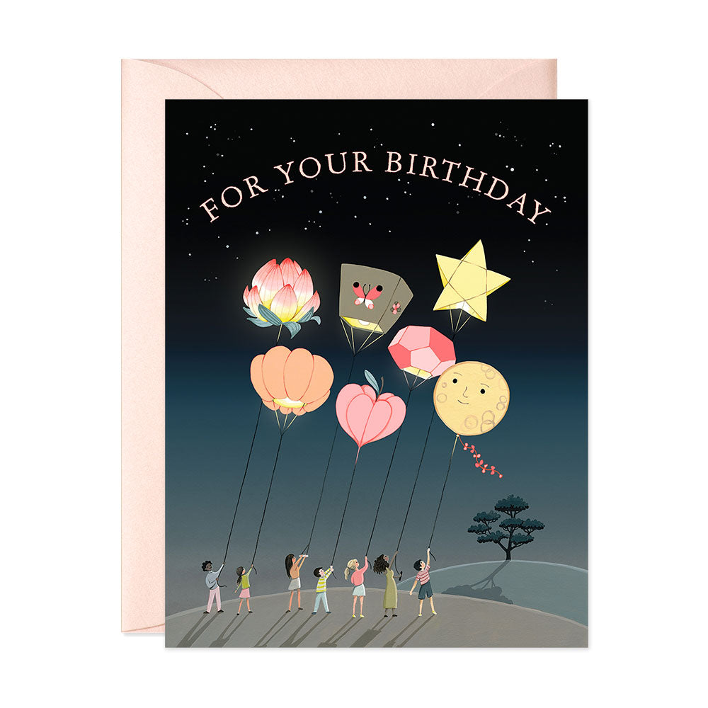 giant lanterns and happy people at night birthday greeting card
