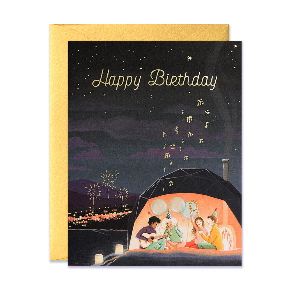 Teenagers camping in aurora dome playing guitar birthday greeting card