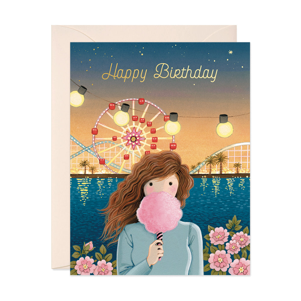 Girl with wavy hair holding a pink cotton candy amusement park birthday card