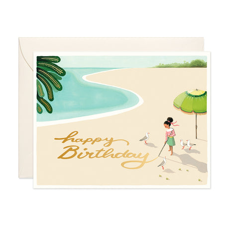 Girl writing on sand with seagulls watching birthday greeting card